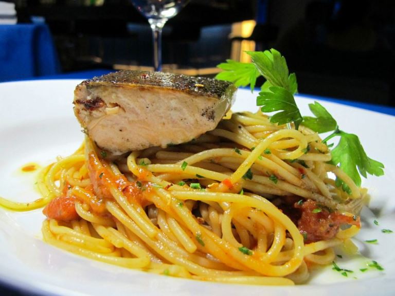 Spaghetti  aglio e olio with grilled  salmonChili flakes, garlic, extra virgin olive oil served with spicy tomato relish