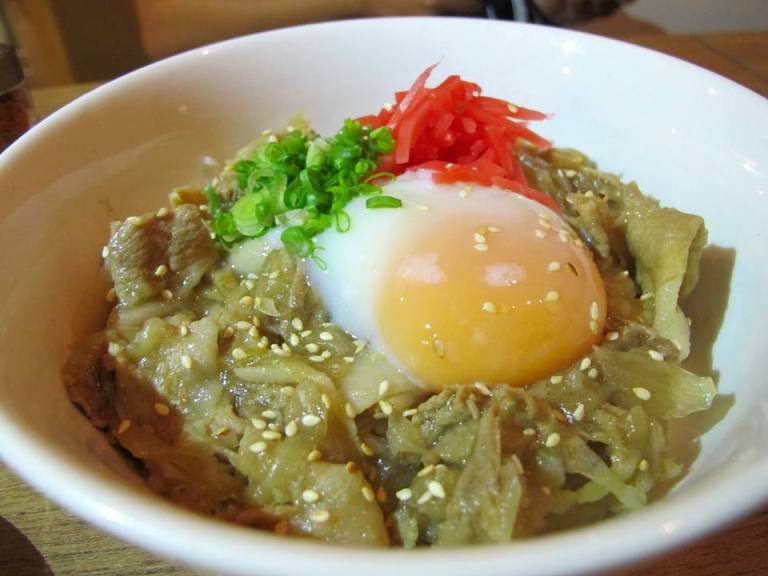 Buta don - pork with rice with an egg on top cooked Japanese style. Break the yolk and mix it well into the pork and rice. This one is a meal on it's own.