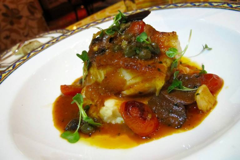 cod medallion stew with Mediterranean vegetables in tangy tomato sauce, lemon chick pea mousse.