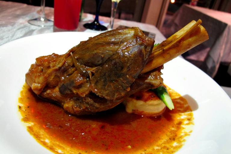 Lamb Shank - Slow-braised lamb shank in tomato gravy served with aromatic vegetables, forester potato, roasted garlic and onion. - RM65