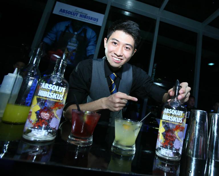 Bar flairing performer Carter Nguyen with the Absolut Hibiskus cocktails