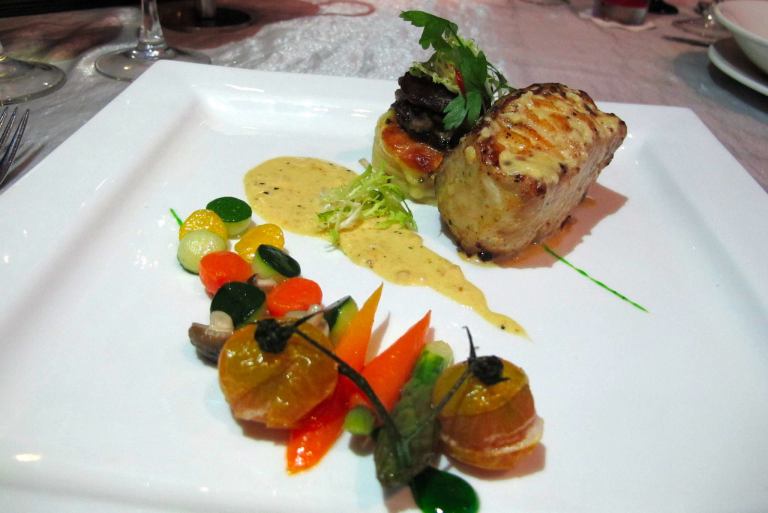 Grilled Black Cod Fish - Pan-fried to perfection and accompanied with mushroom ragout, mixed baby vegetables, forester potato and garlic saffron cream sauce. - RM58