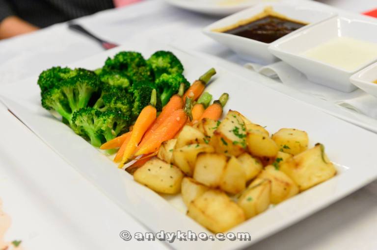 Accompanying the ribeye was a whole plateful of brocolli, baby carrots and potatoes.