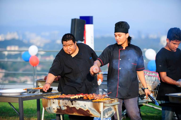 The chefs busy preparing the food