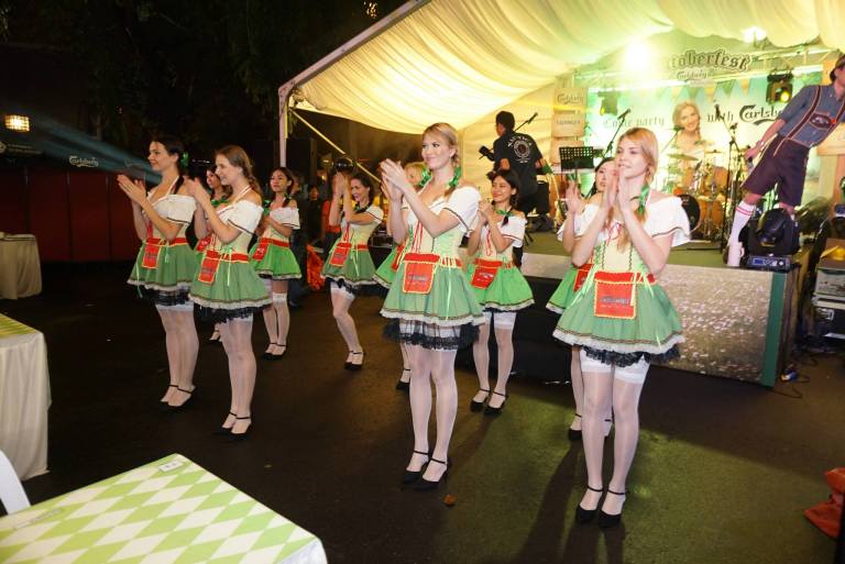 The Oktoberfest girls in the traditional dirndl will dance with you