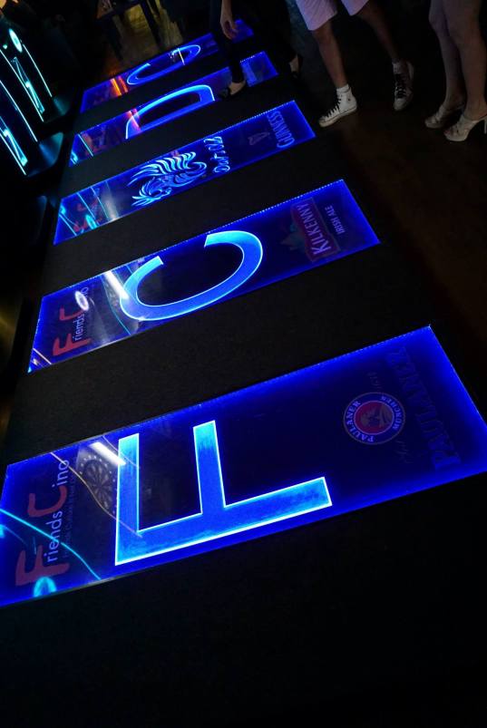 In place of the normal mat which measures the minimum distance  is a slightly raised and lit platform which effectively stops players from encroaching over the minimum distance.