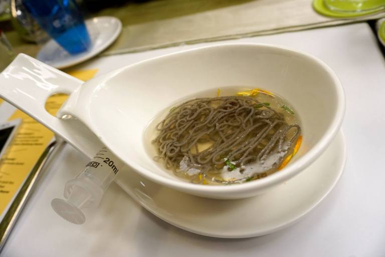 The soup which is served around 60+ degrees Celcius cooks and solidifies the noodle and you can scoop it up with a fork just like you would a eating a bowl of noodles!