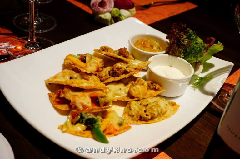 Nachos - A choice of chicken or vegetarian with cheddar cheese on crispy corn tortilla chips - RM19.00 Accompanied with guacamole and sour cream, and perfect for sharing! Love the jalapeno chillis on top too!