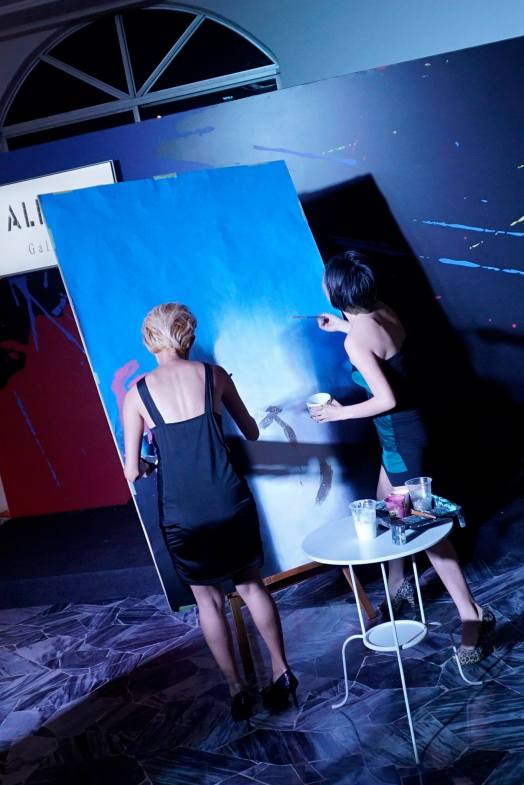 These two (2) girls set about creating a painting within 10 minutes