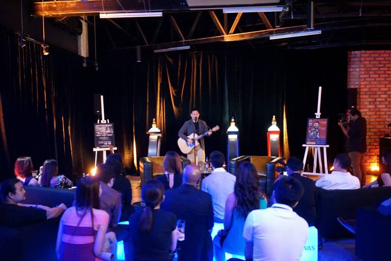 Douglas performing the theme song from Kopitiam