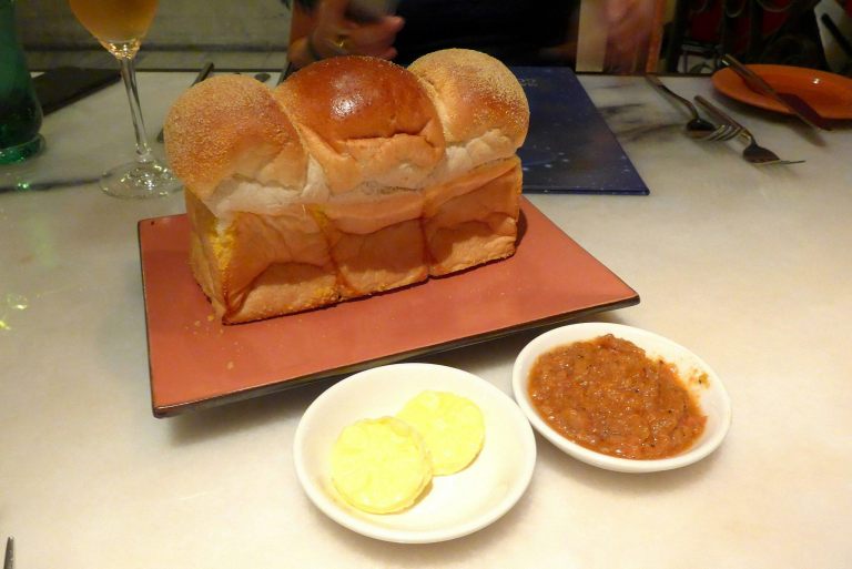 Complimentary bread served with butter and a tomato spread