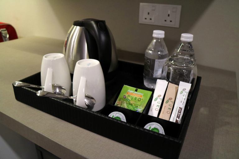 Bottled water, kettle and mugs and teabags to make drinks