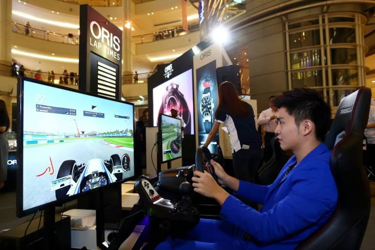 Guests trying out the racing simulator