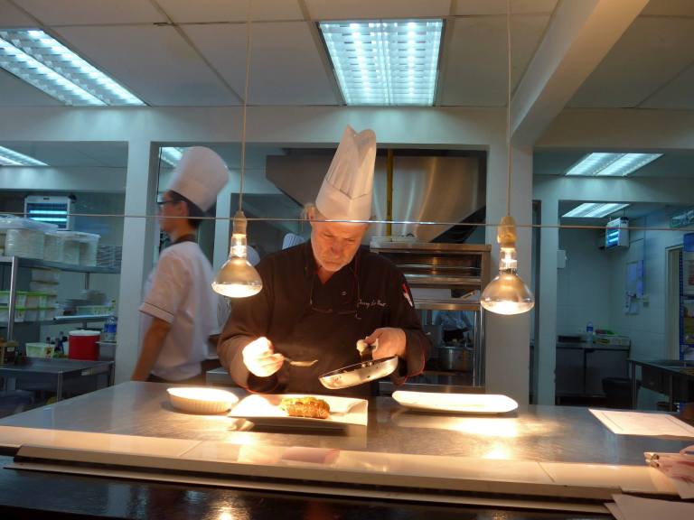 Chef Thierry preparing food in the open kitchen