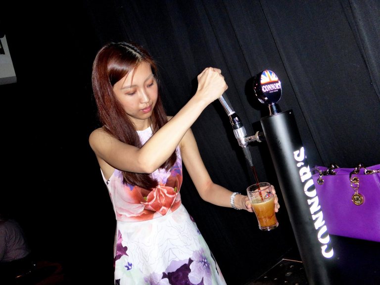 My partner in crime tapping her own pint of Connor's Stout Porter. She turned out to be quite good at it!
