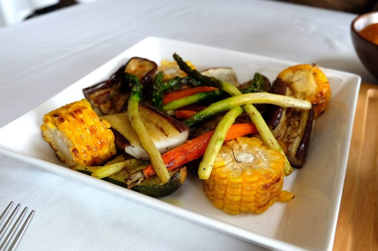 The sides which includes roasted spring vegetables like corn and asparagus