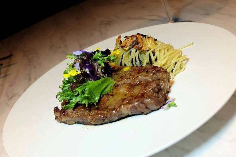 Wagyu MB9 - Wagyu Marbling 9 butter seared and served with Aglio Olio Pasta, Mesclun and Herbed Balsamic Aged Vinaigrette - RM288