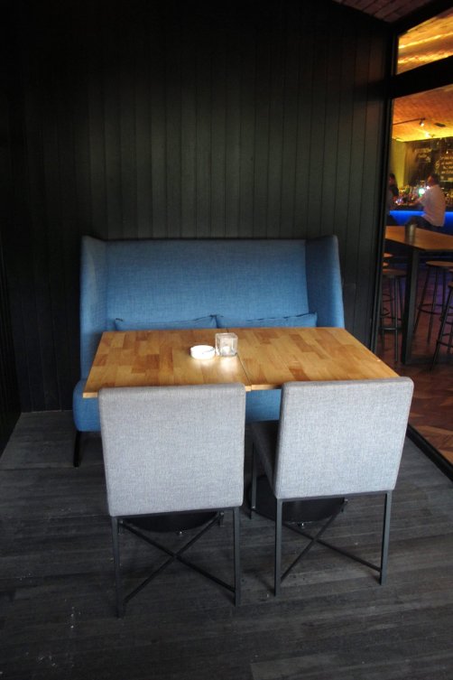 Sofa tucked away in a corner of the open air area