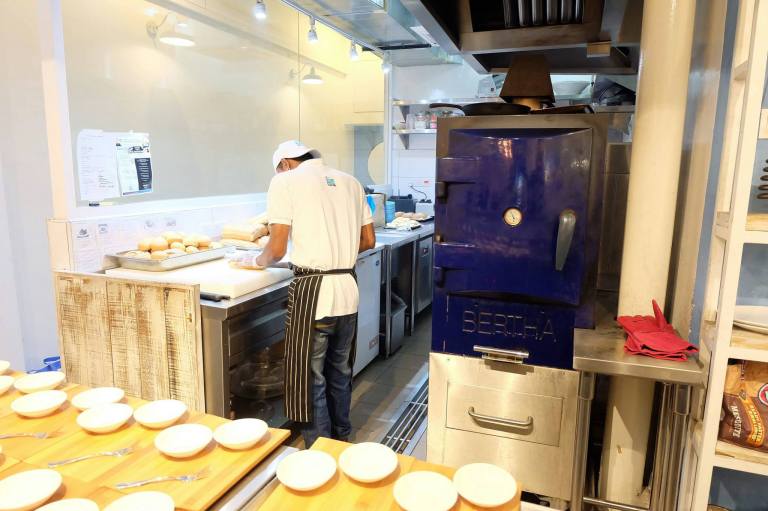 The open kitchen contains a Bertha oven