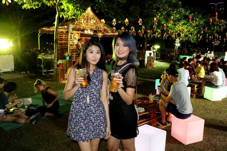 An outdoors night portrait shot in patchy yellow lighting