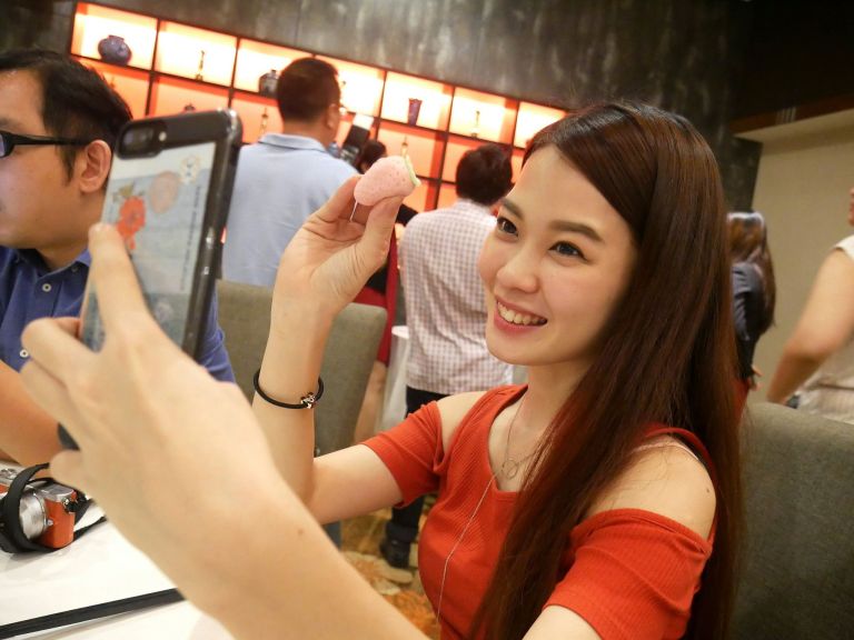 Most girls couldn't resist the temptation to take photos of/ with the cute dessert