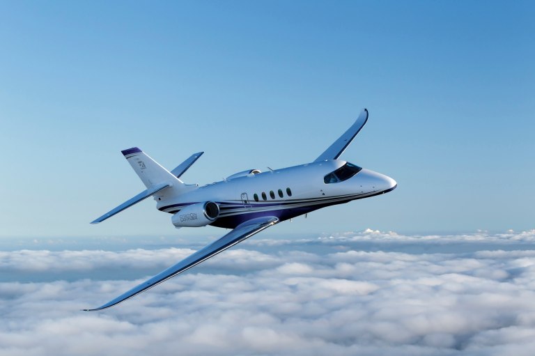 Cessna Citation Latitude flying in the sky above clouds