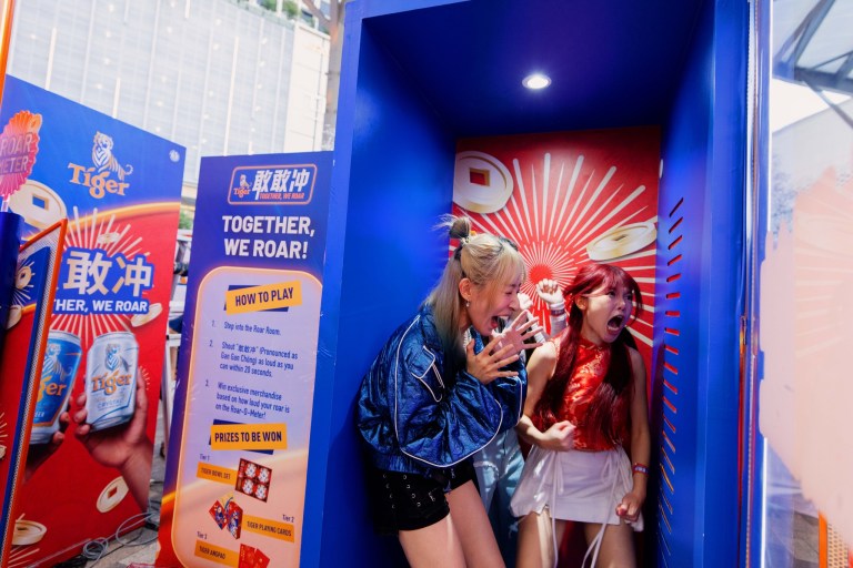 Guests trying out the 'Together, We Roar' activity at Tiger Town