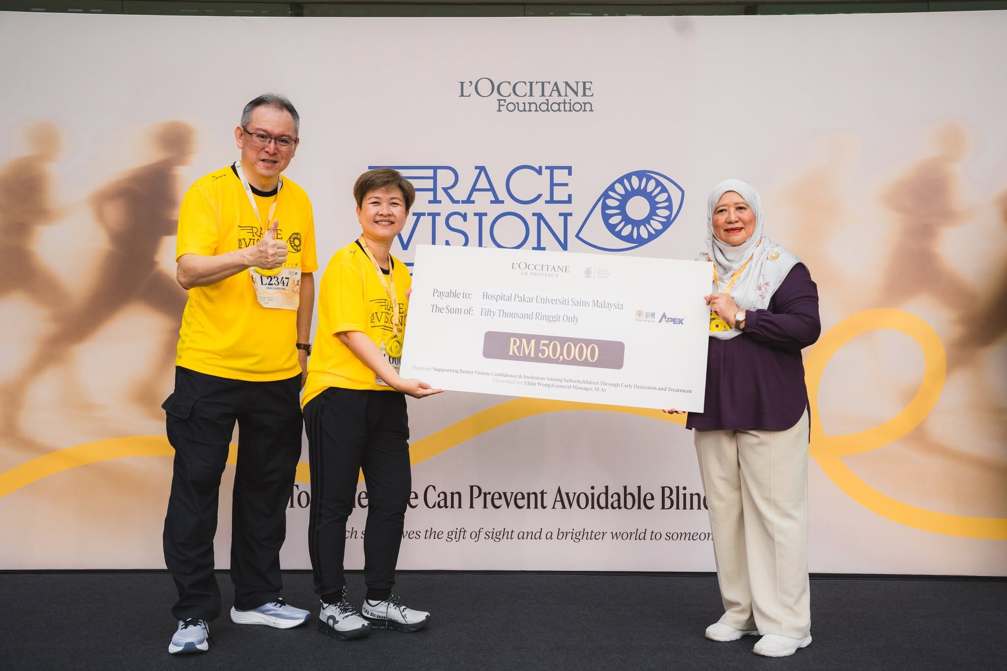 Mock cheque presentation by L'OCCITANE Malaysia's top management team:Mr Sing Loonpoh, Deputy General Manager of L'OCCITANE Malaysia (left), and Ms Elida Wong, General Manager of L'OCCITANE SEA (centre), with Professor Dr Shatriah Ismail, Deputy Director of Hospital Pakar Universiti Sains Malaysia (right).