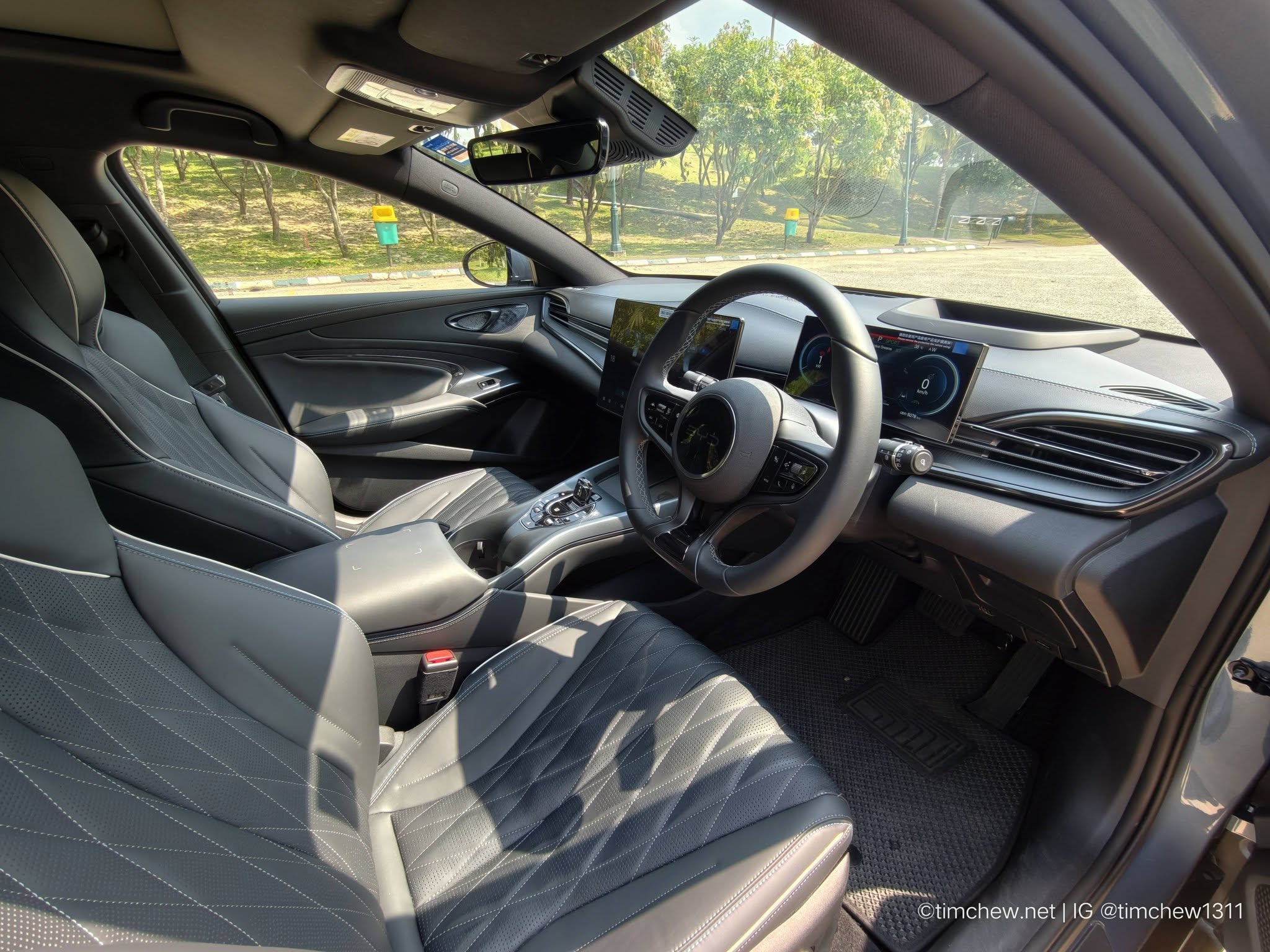 Interior view of a modern car showcasing sleek leather seats, a minimalist dashboard with digital displays, and a well-lit cabin.